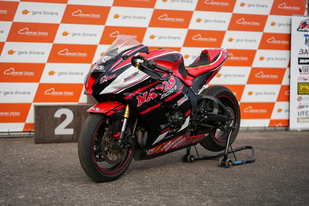 Kawasaki Ninja Bike Red Kawasaki Ninja ZX-6R superbike parked at a motorsport podium event.