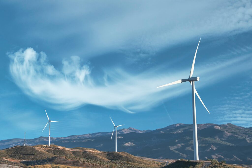 Alternatives to LPG in the USA Wind turbines on a hillside capturing clean energy under a serene blue sky.