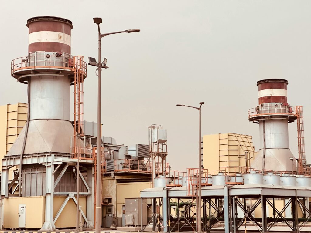 View of industrial power plant towers in Saudi Arabia, showcasing modern energy infrastructure.
