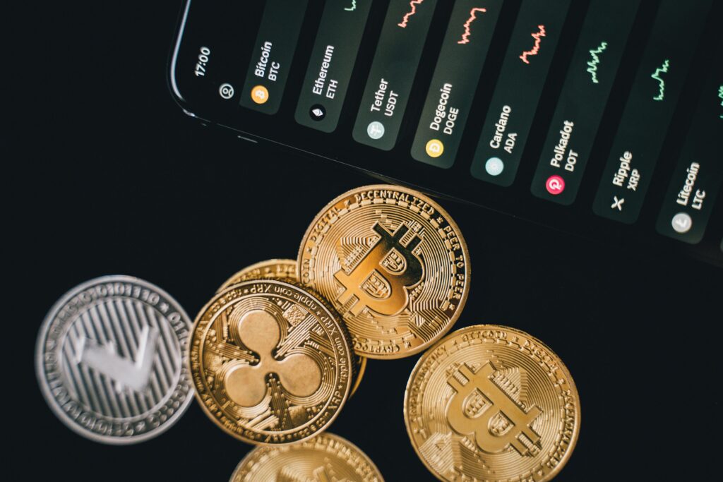 XRP Price in the USA Close-up view of various cryptocurrency coins with a digital market display in the background.