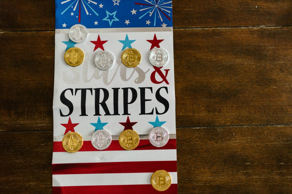 Patriotic themed arrangement with crypto coins on a stars and stripes background.