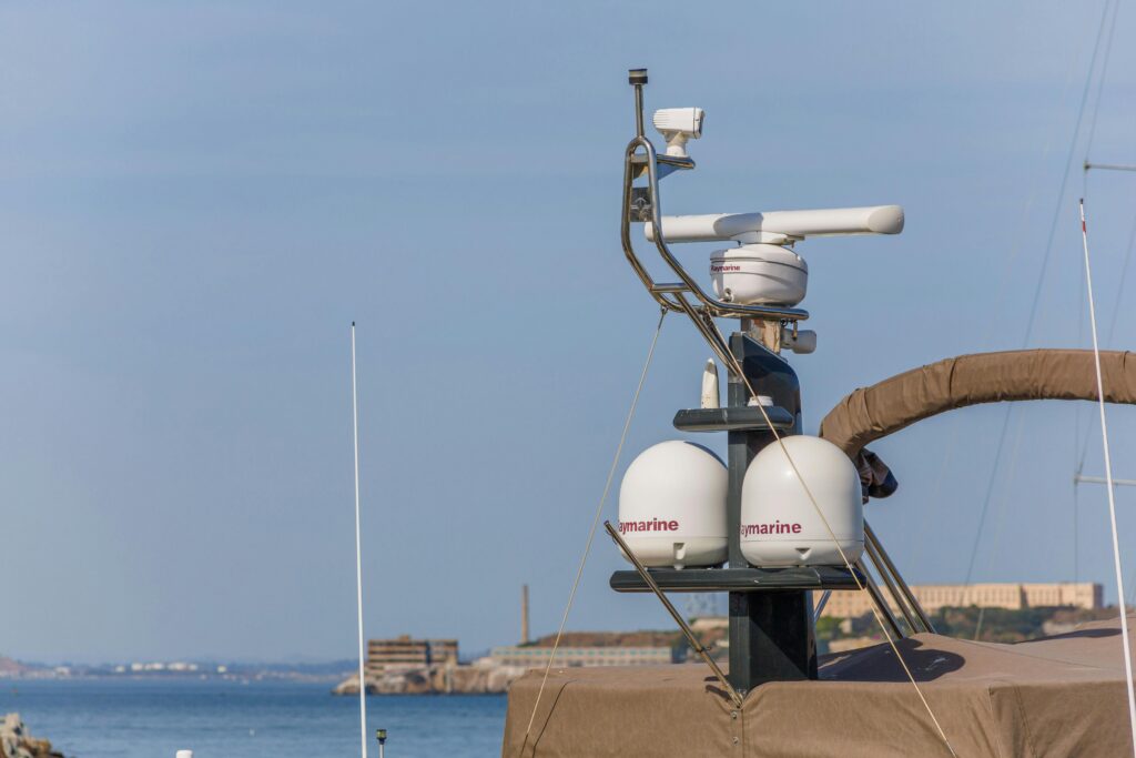 Radar Systems Used in the USA Close-up of radar navigation equipment on a yacht against a sunny coastal backdrop.